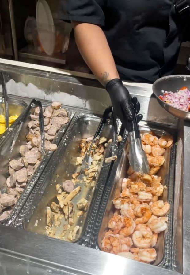 Cafeteria worker serving food at a hospital. 