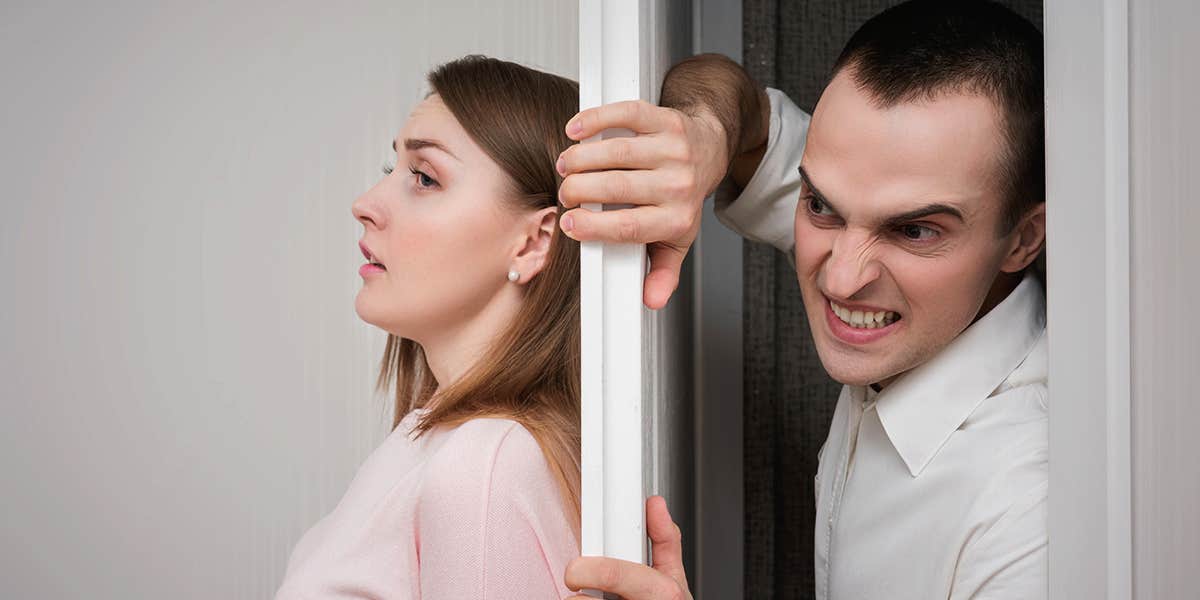 Young woman in horror trying to hide from her boyfriend