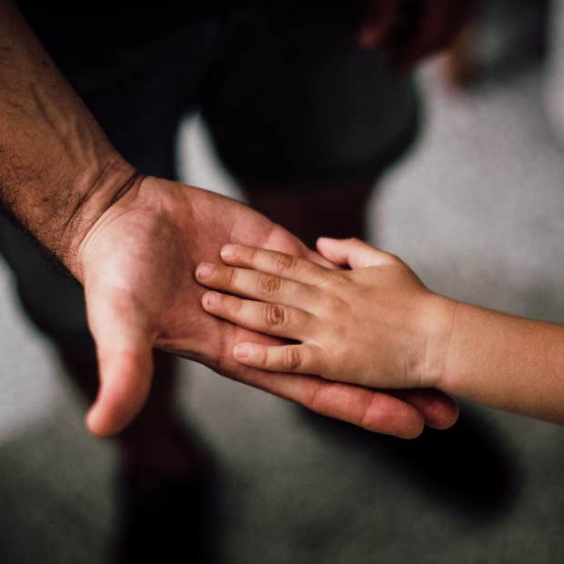 child&#039;s hand on an adult&#039;s hand