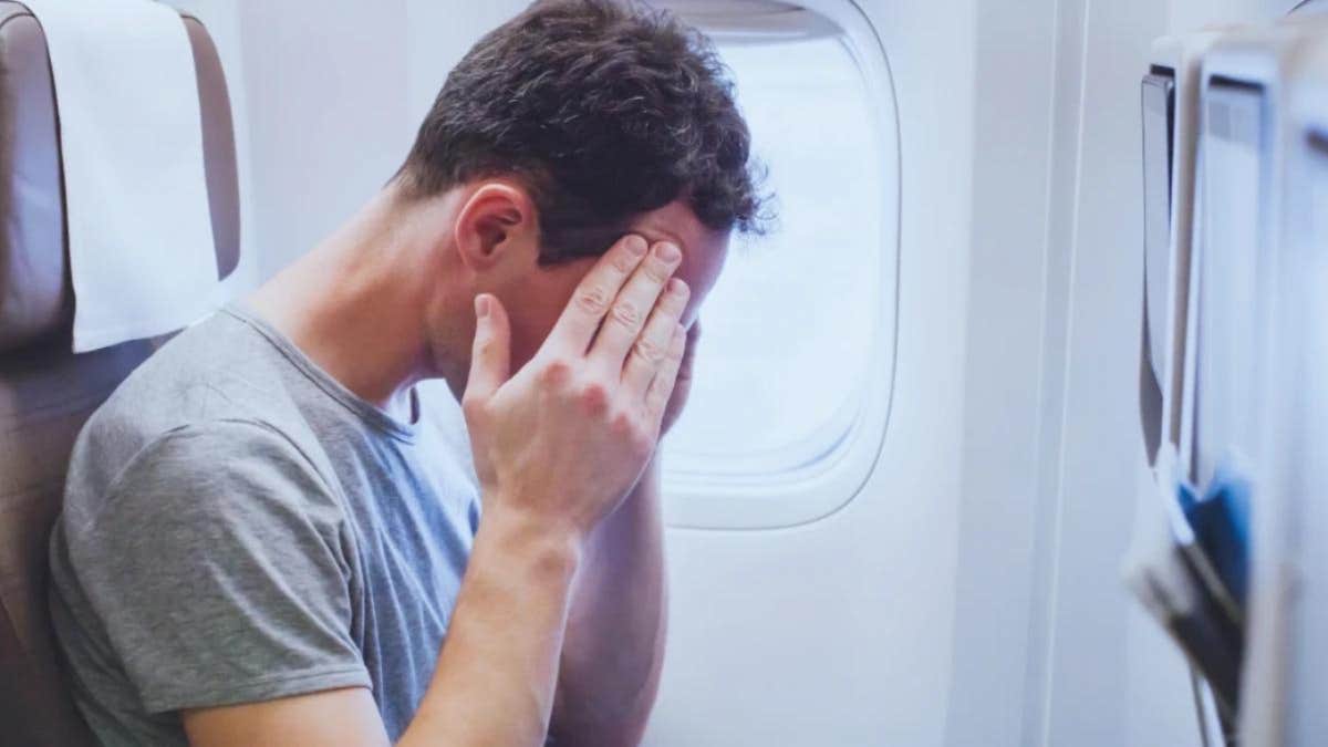 stressed man on plane