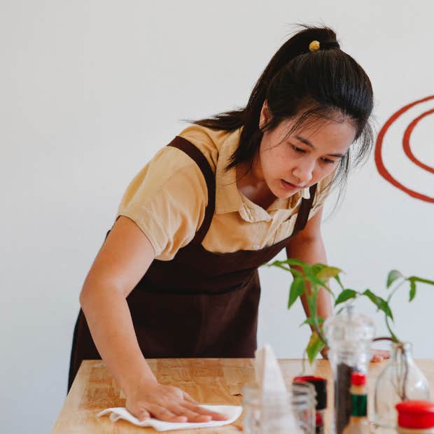 restaurant worker cleaning table