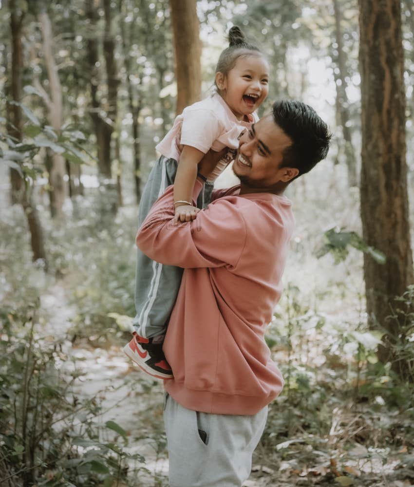 man playing with young daughter