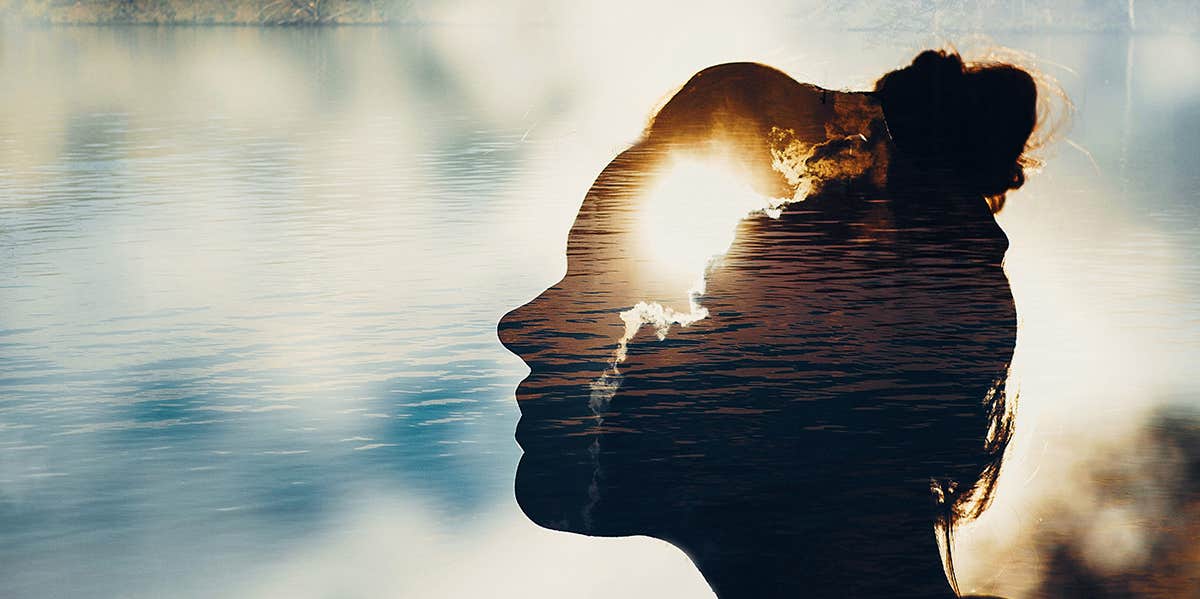 strong woman silhouette with light shining through brain
