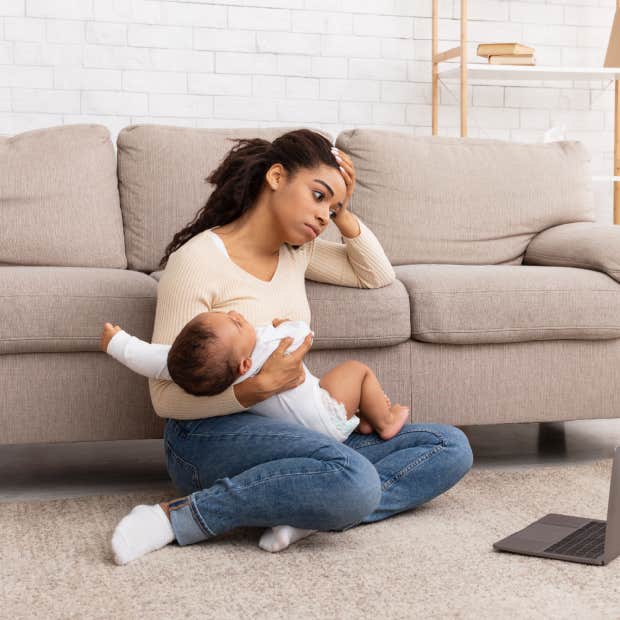 tired mom holding baby