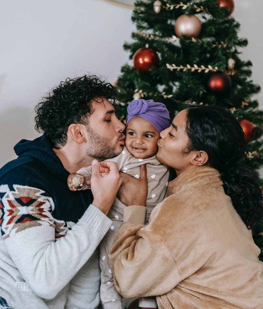 couple kissing baby on the cheeks