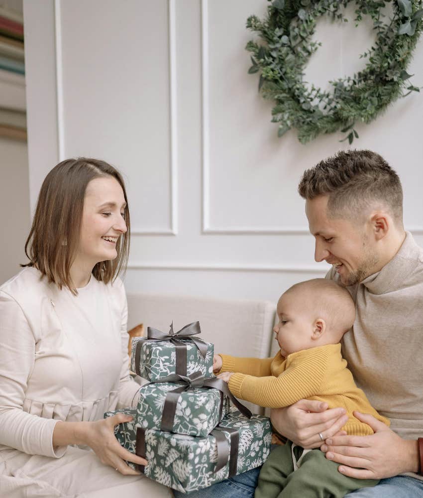 baby touching wrapped christmas presents