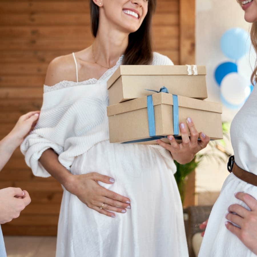 pregnant woman receiving gifts at baby shower