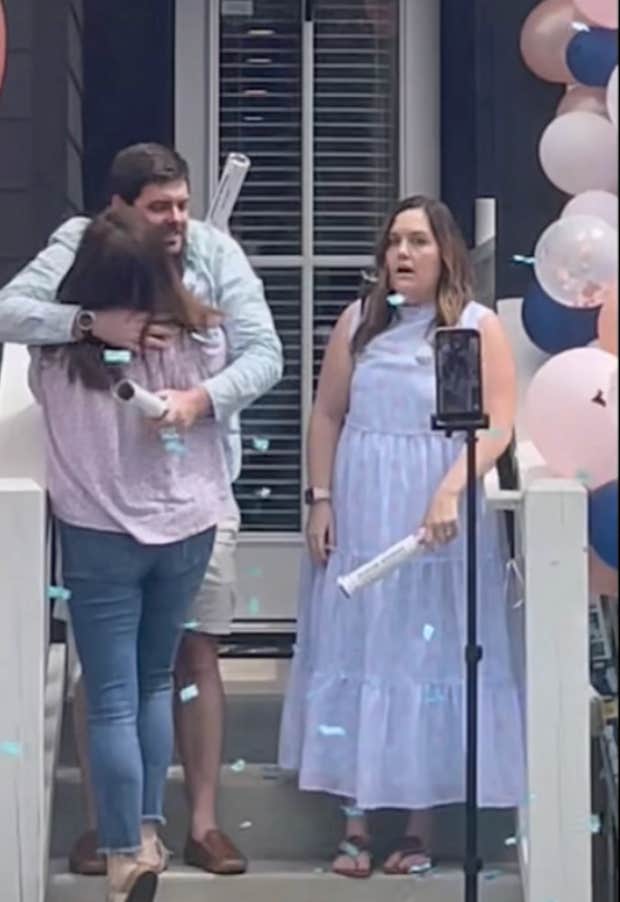 mother-in-law hugging son during gender reveal