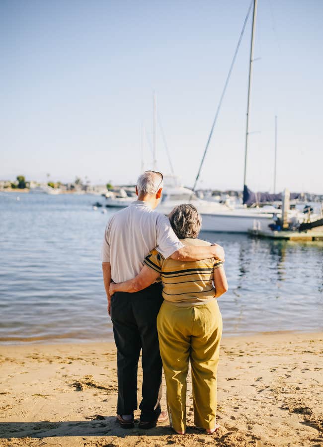 older couple embracing on the beach