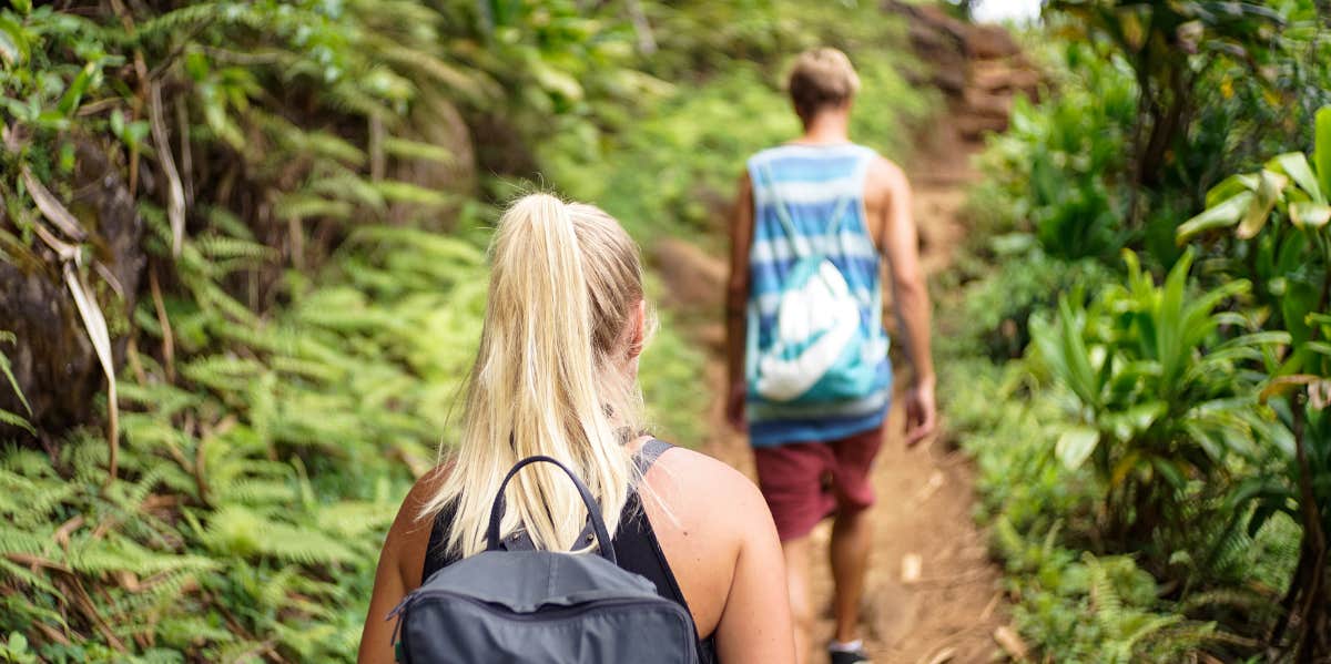 boyfriend walking ahead of girlfriend, leaving her behind