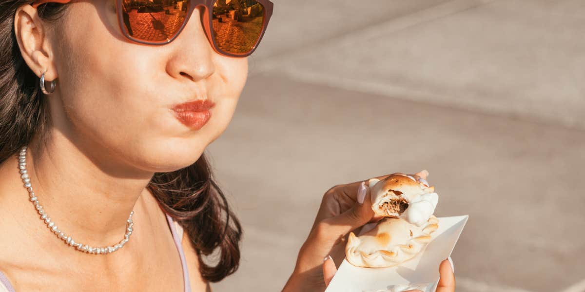 woman chewing sandwich