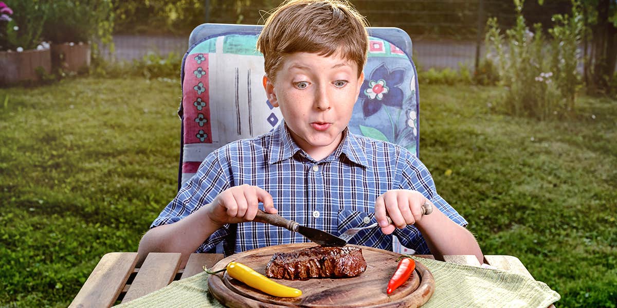 Man Asks If He Was Wrong For Making His Brother-In-Law Pay For His Son's Meal Even Though He Said It Was His Treat boy eating a steak