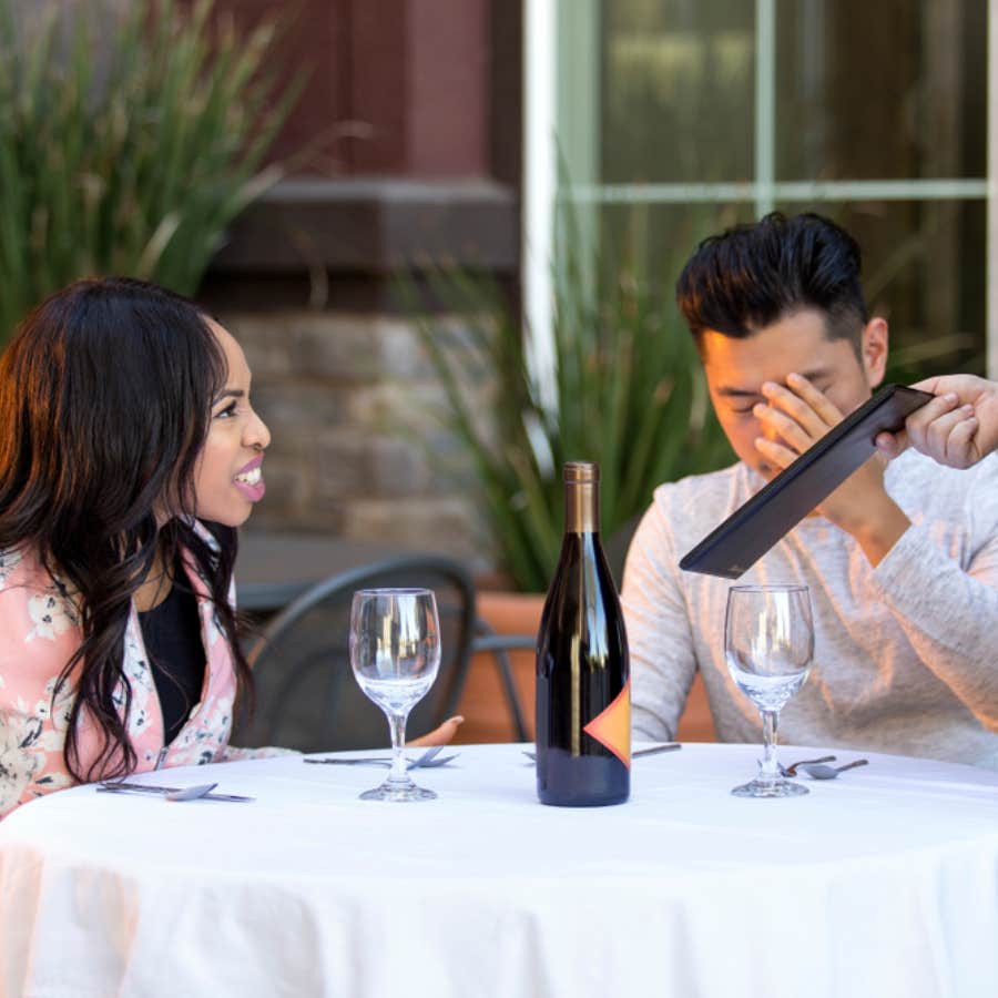 woman yelling at server from dinner table in front of embarrassed man