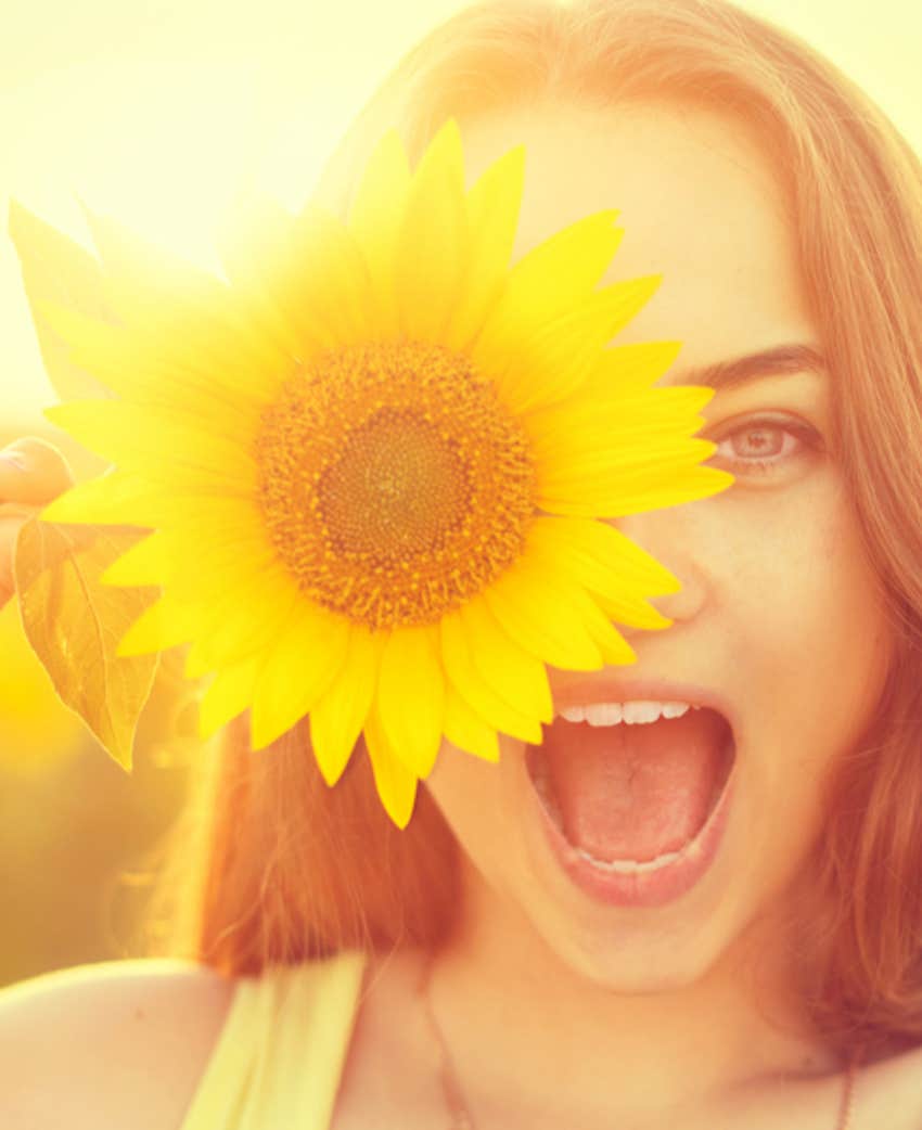 enthusiastic woman with sunflower