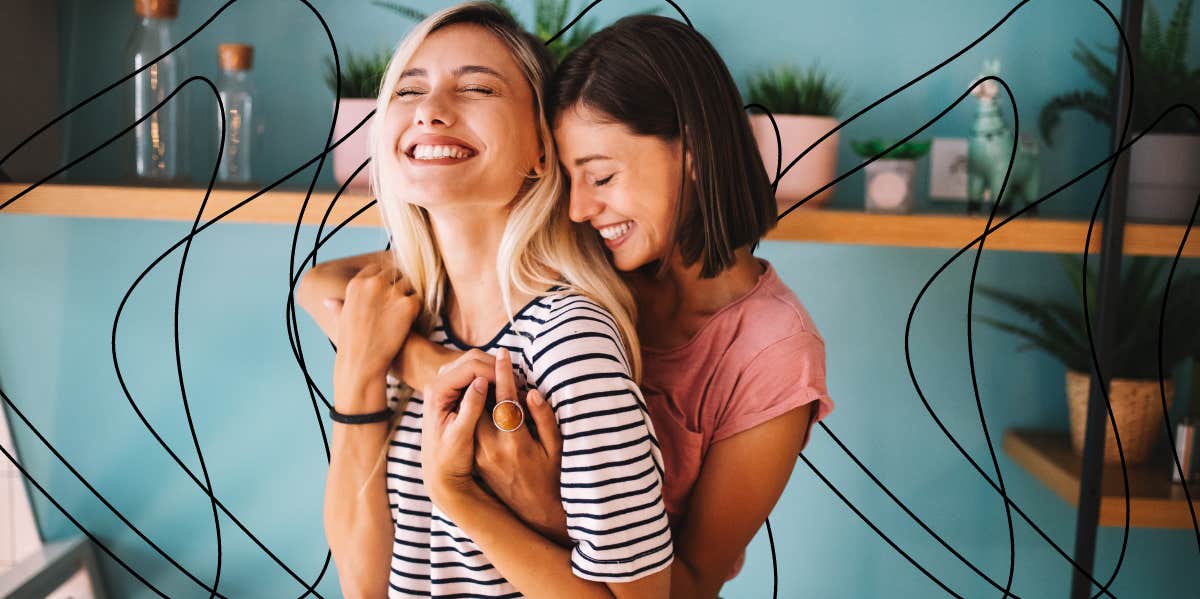 two women hugging each other smiling