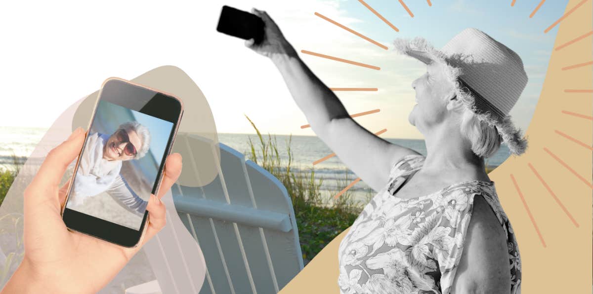 Older woman near the beach happily taking selfies