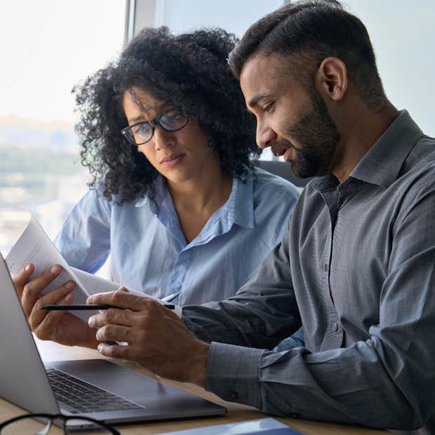 man and woman looking at paperwork