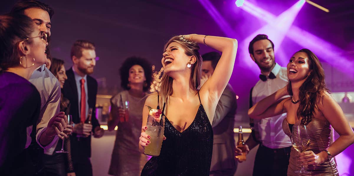 woman center of attention dancing freely at club