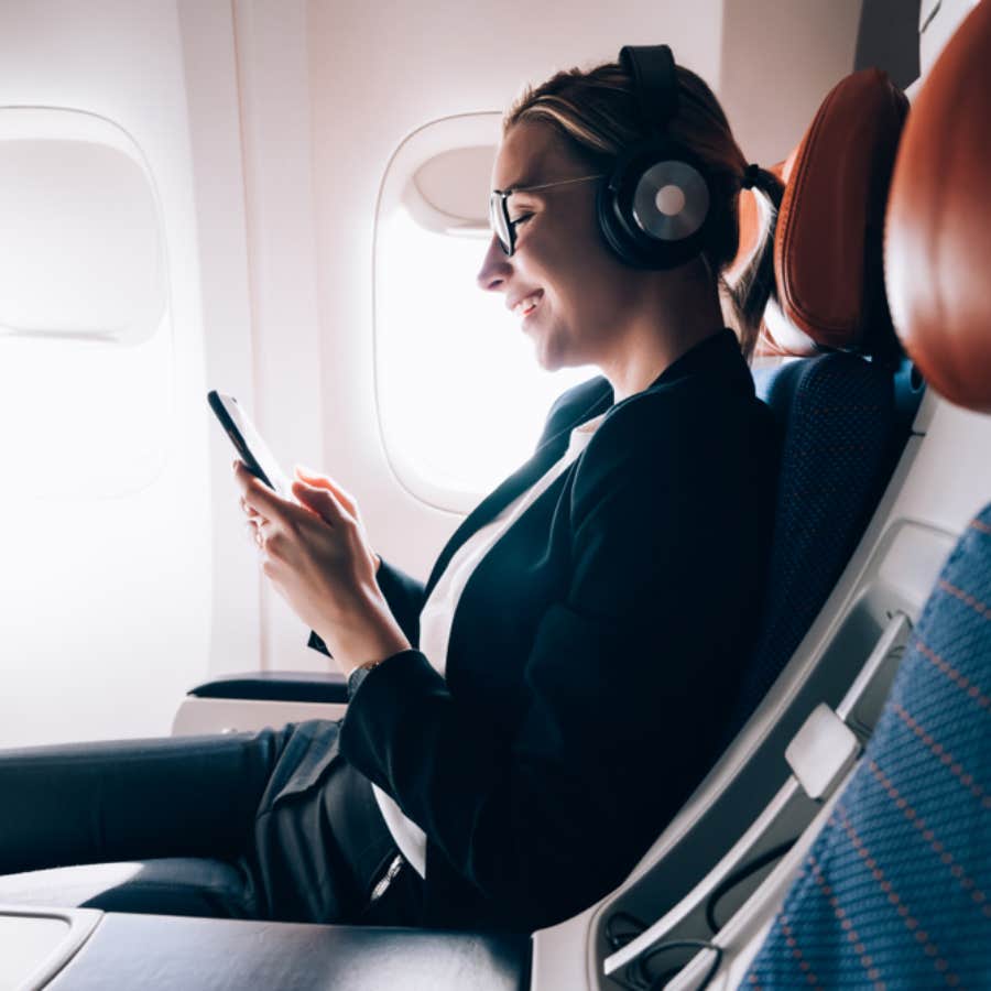 woman wearing headphones on a plane