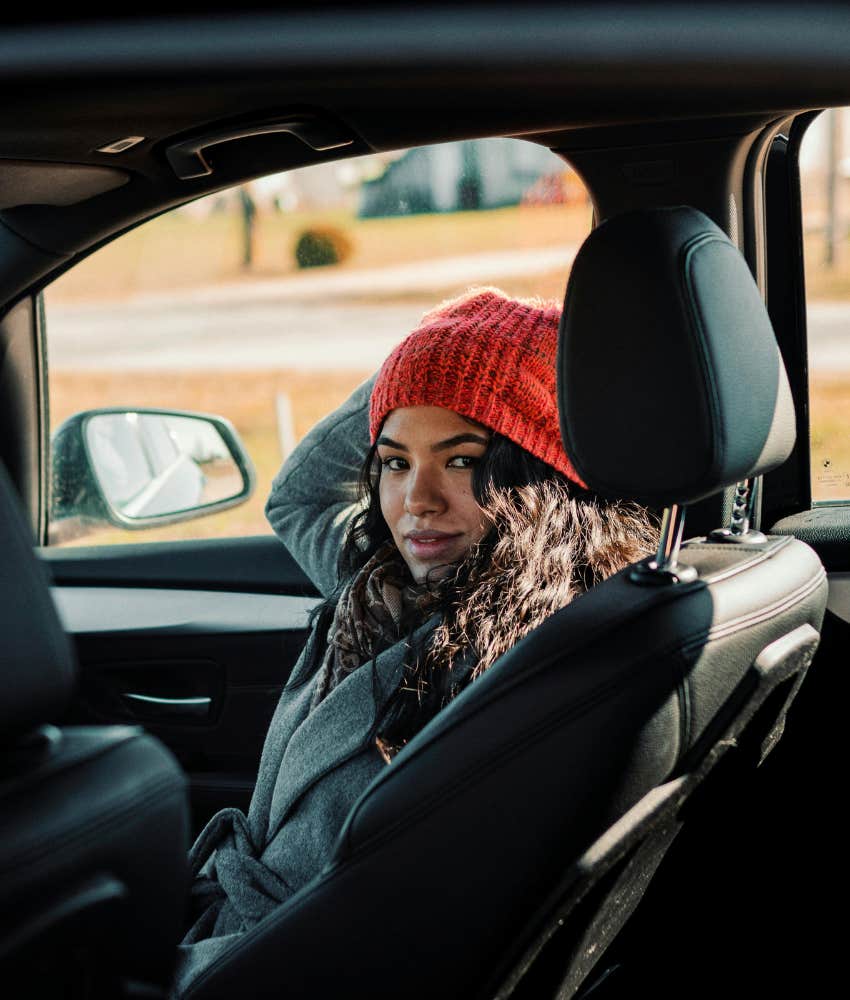 young woman sitting in a car