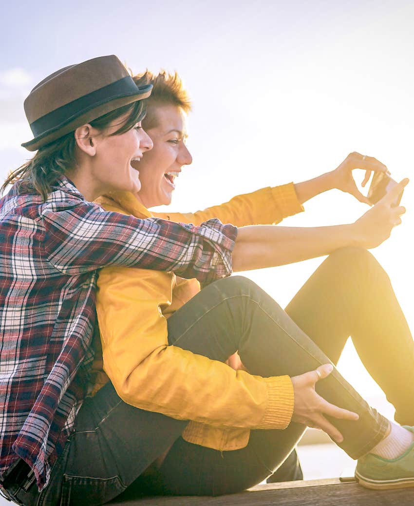 couple laughing outside taking a selfie
