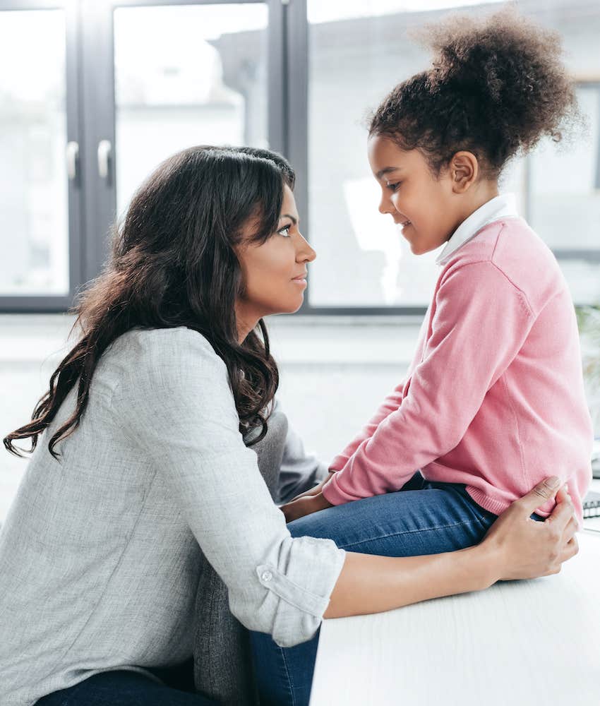 mother patiently explaining to daughter