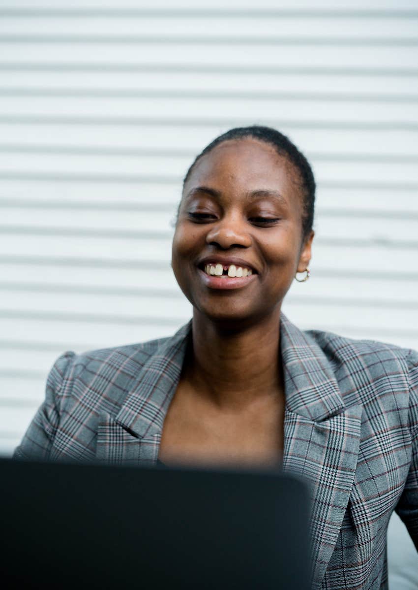 woman smiling while making a video call 