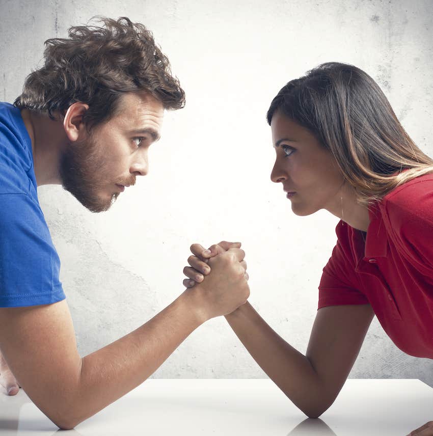 Couple arm wrestles 