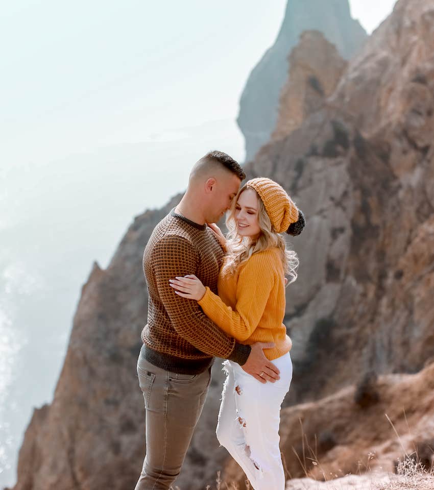 AMn and woman hug on a mountain