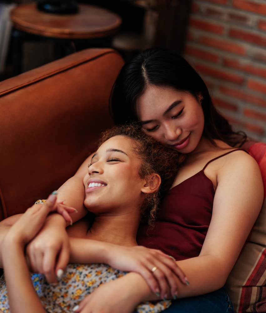  couple is on their living room couch enjoying themselves and lovingly cuddling.