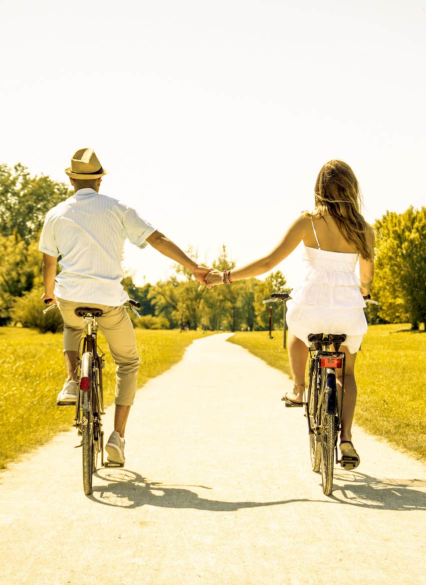 Couple of romantic lovers cycling