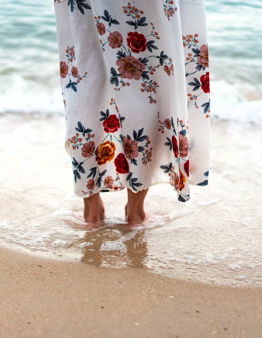 woman stand alone on the silent beach