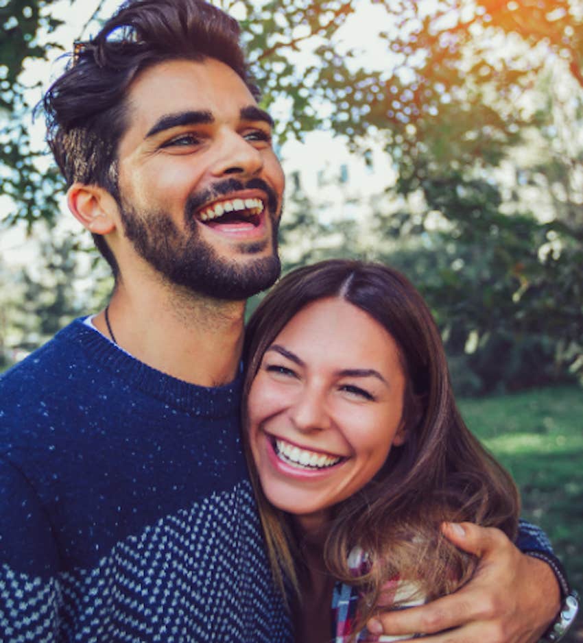 happy couple hug and laugh