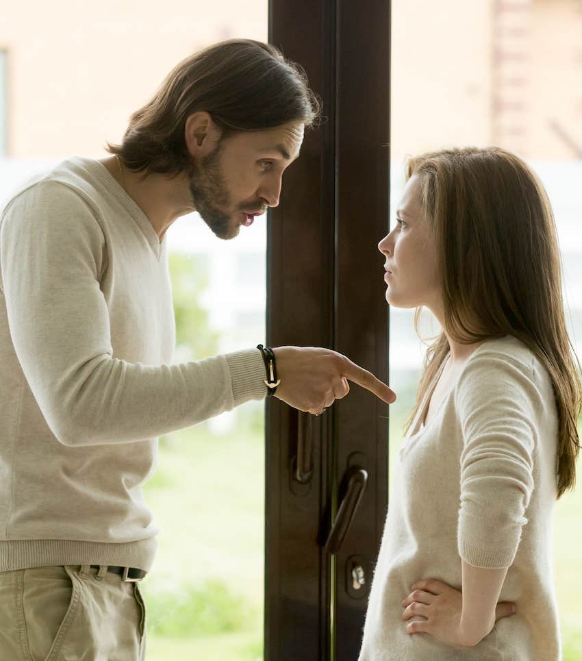 he points his finger at her chest