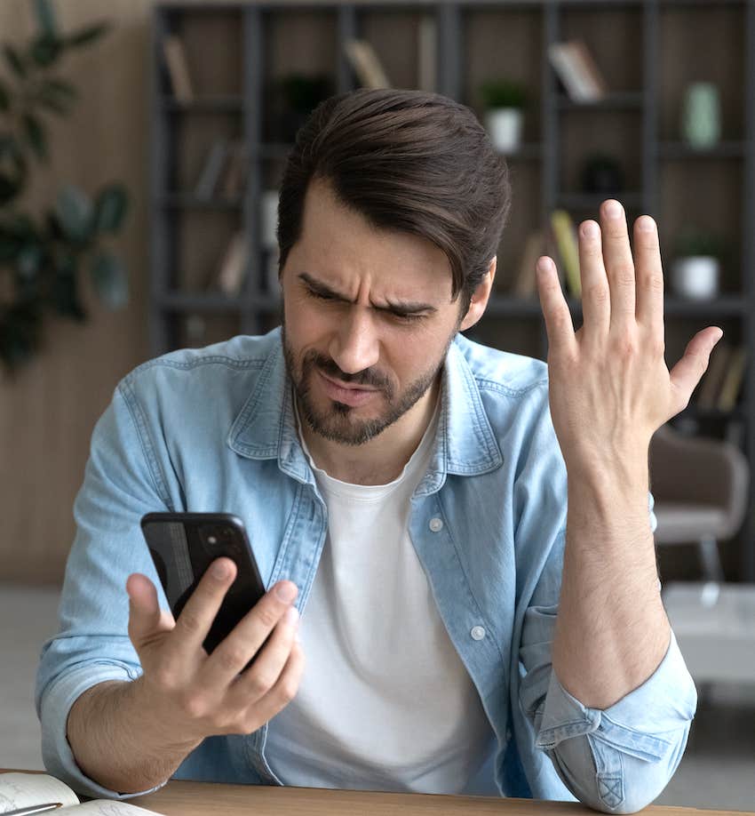 Upset male outraged by smartphone