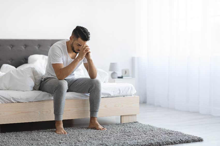 upset man sitting on a bed