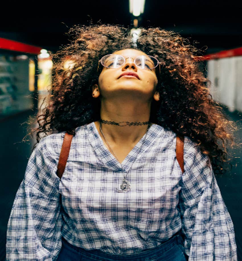 woman in tunnel looks up in frustration