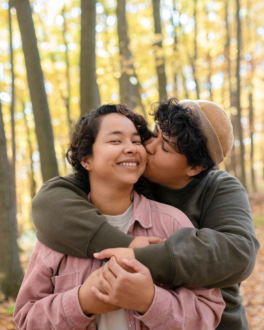 couple embracing in the woods in autumn