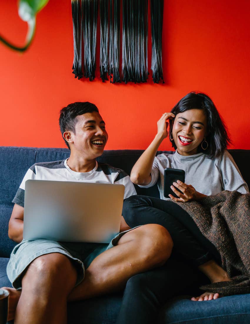 couple on couch relaxed and happy.