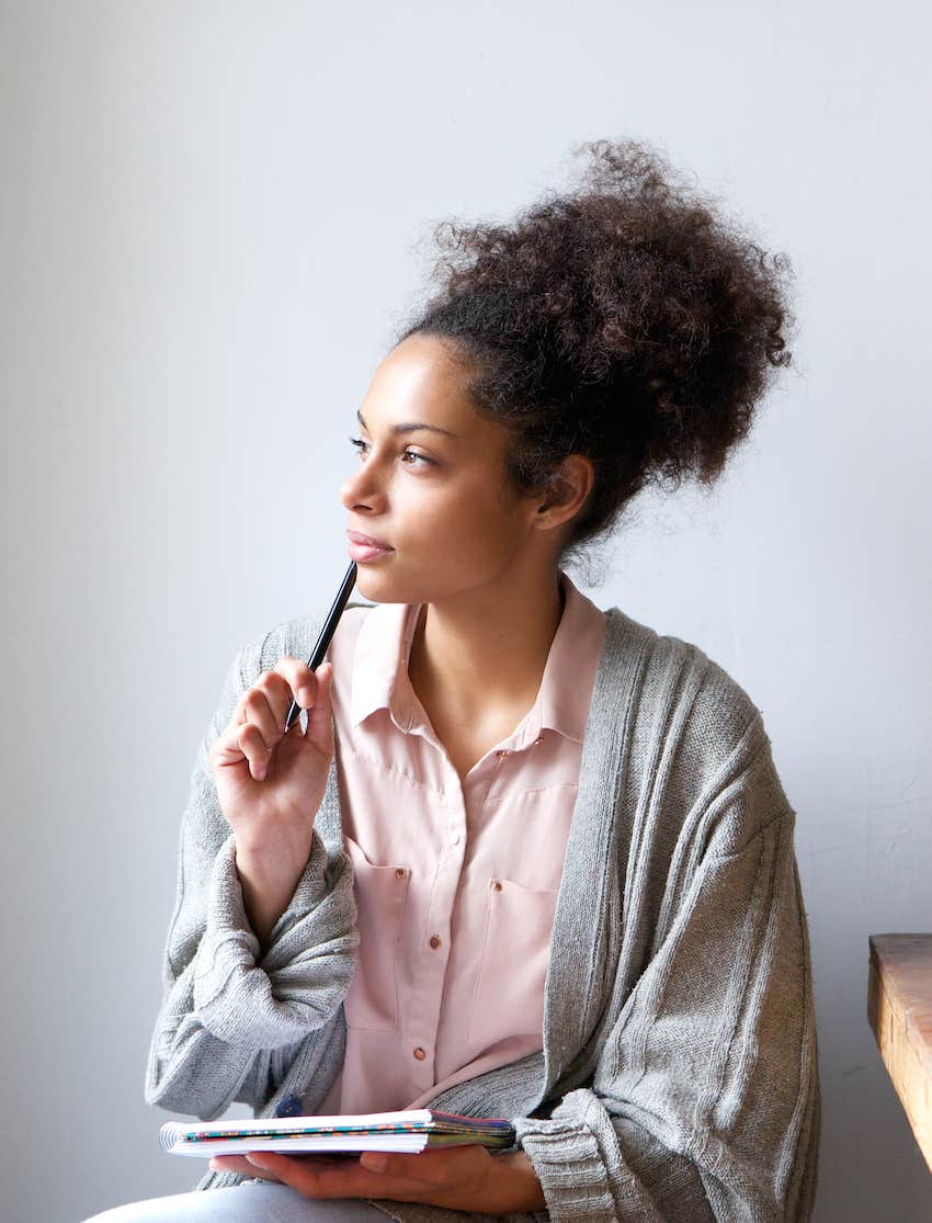 woman sitting at home with pen and paper