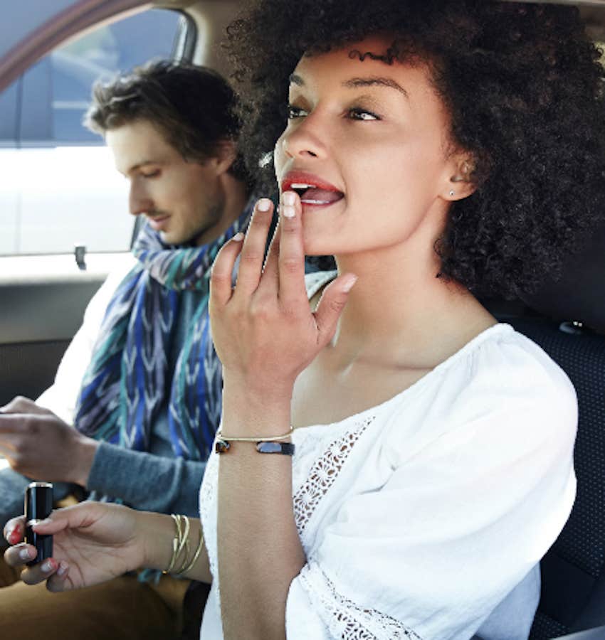 couple in car doing their own things