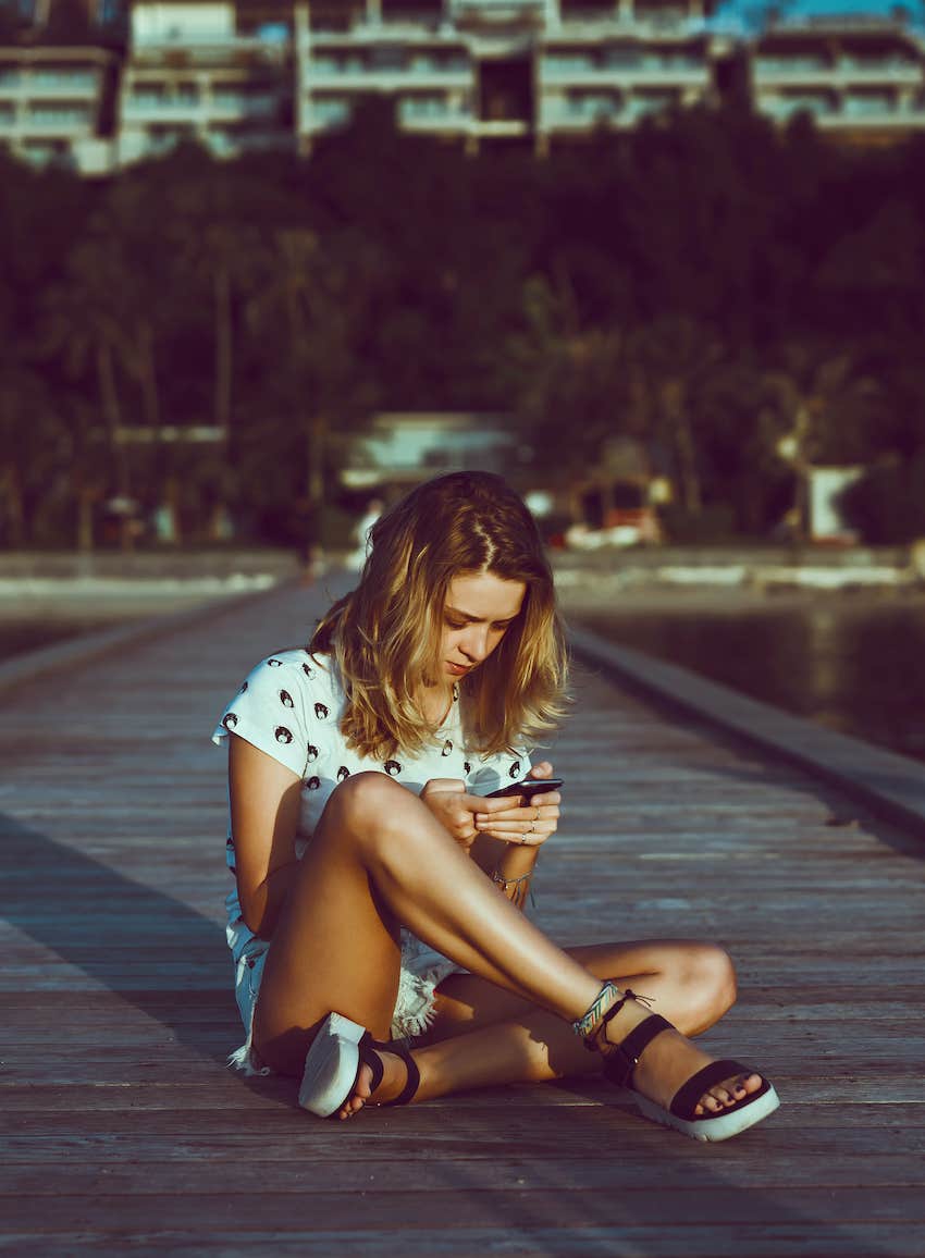 teen girl alone focused on her phone