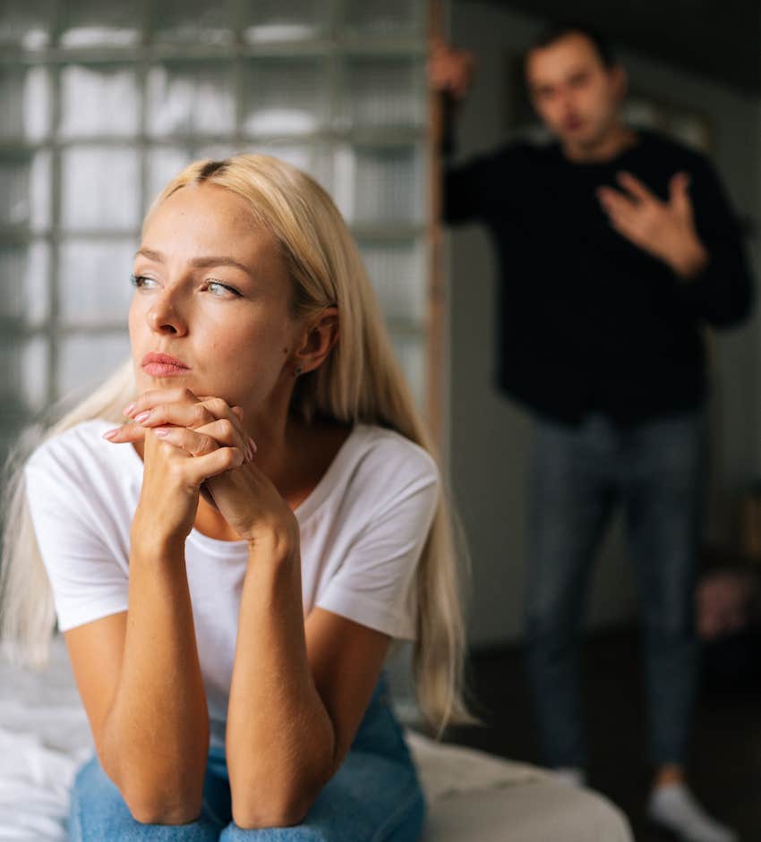 stressed woman tries to ignore husband arguing