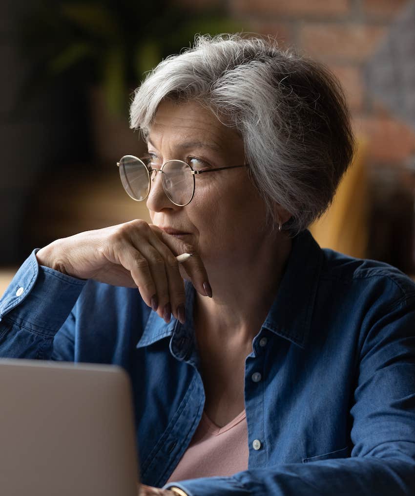 woman thinks about retirement plans while looking out window