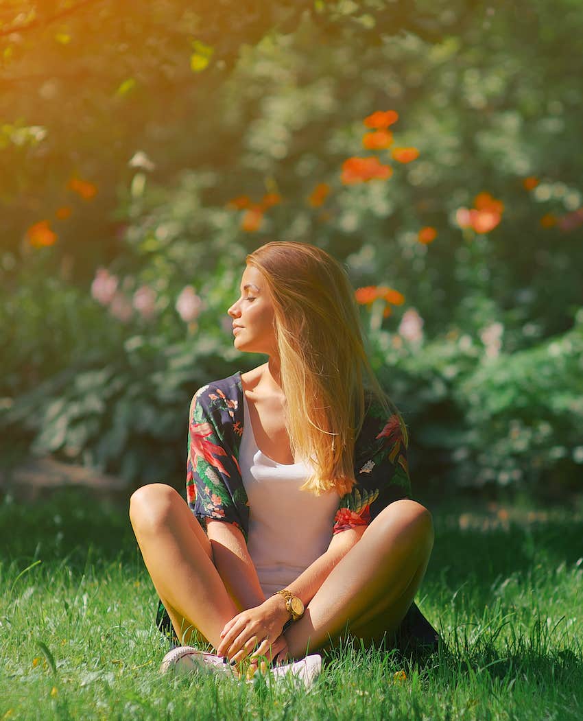 sitting on grass with sun on her face