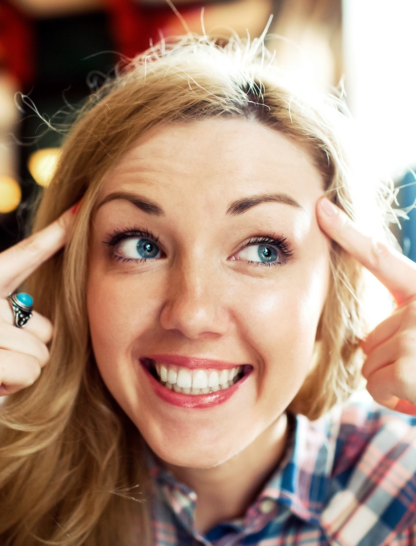 happy woman point at both sides of her head