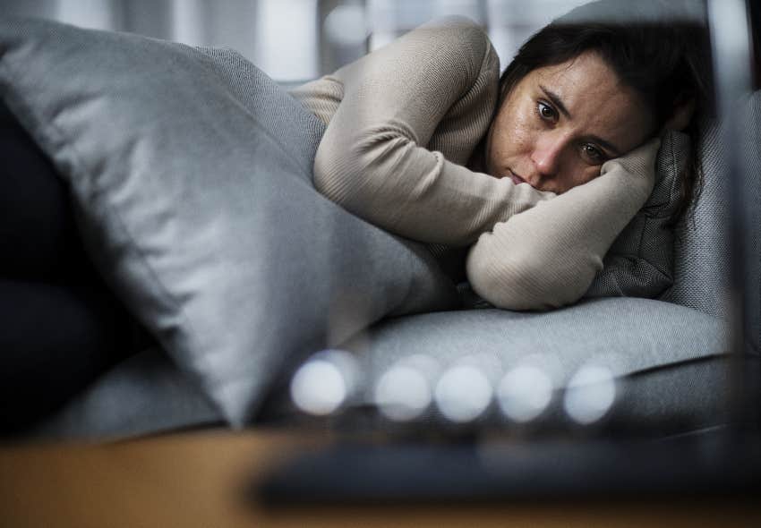 depressed woman laying in bed