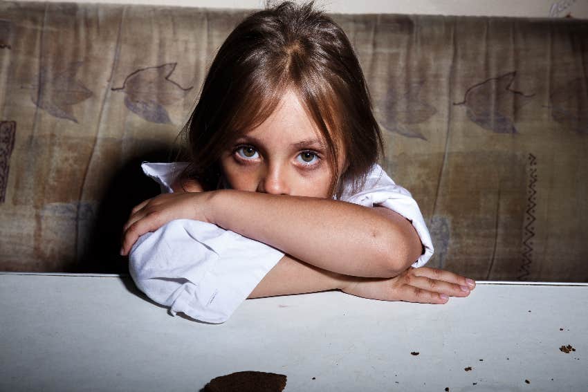 sad young girl sitting in dirty booth