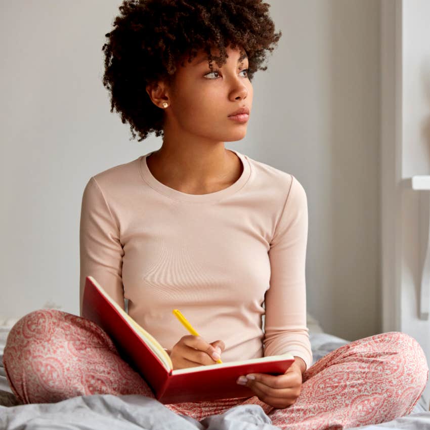 woman writing in her journal