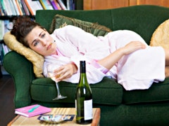 Woman drinking wine on couch